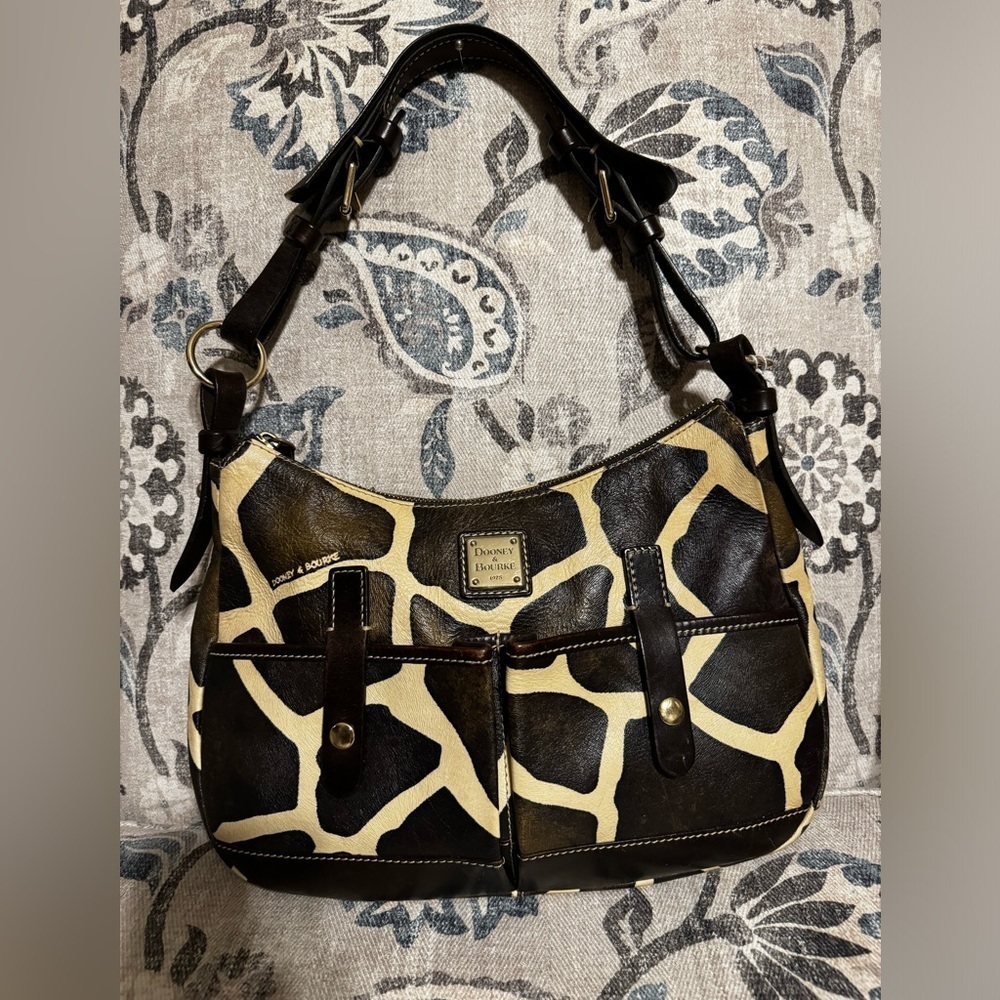 Dooney and Bourke shoulder bag in a giraffe print style.
